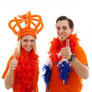 Couple of Dutch soccer supporters cheer over white background